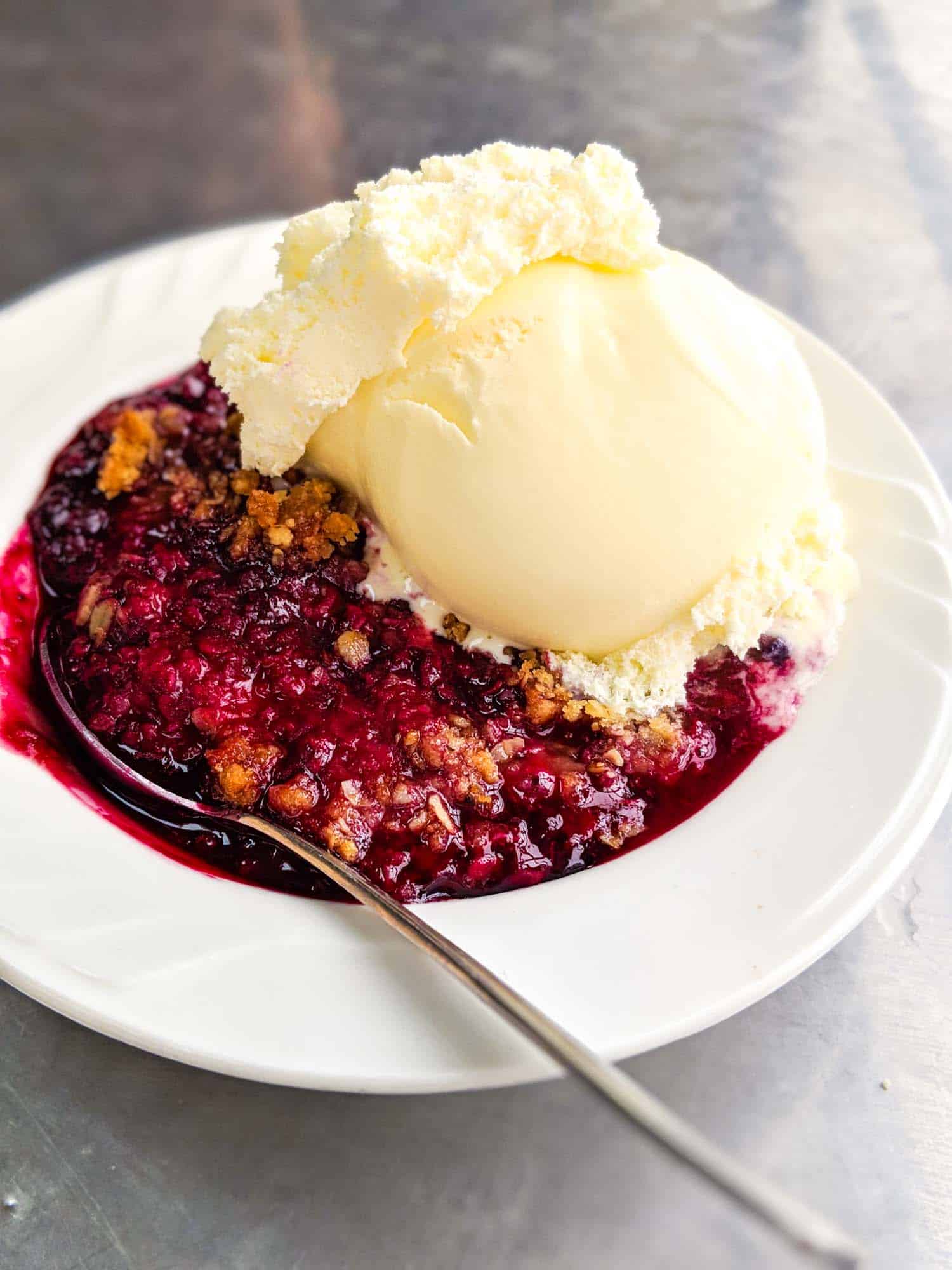 Mixed berry crisp with vanilla ice cream.