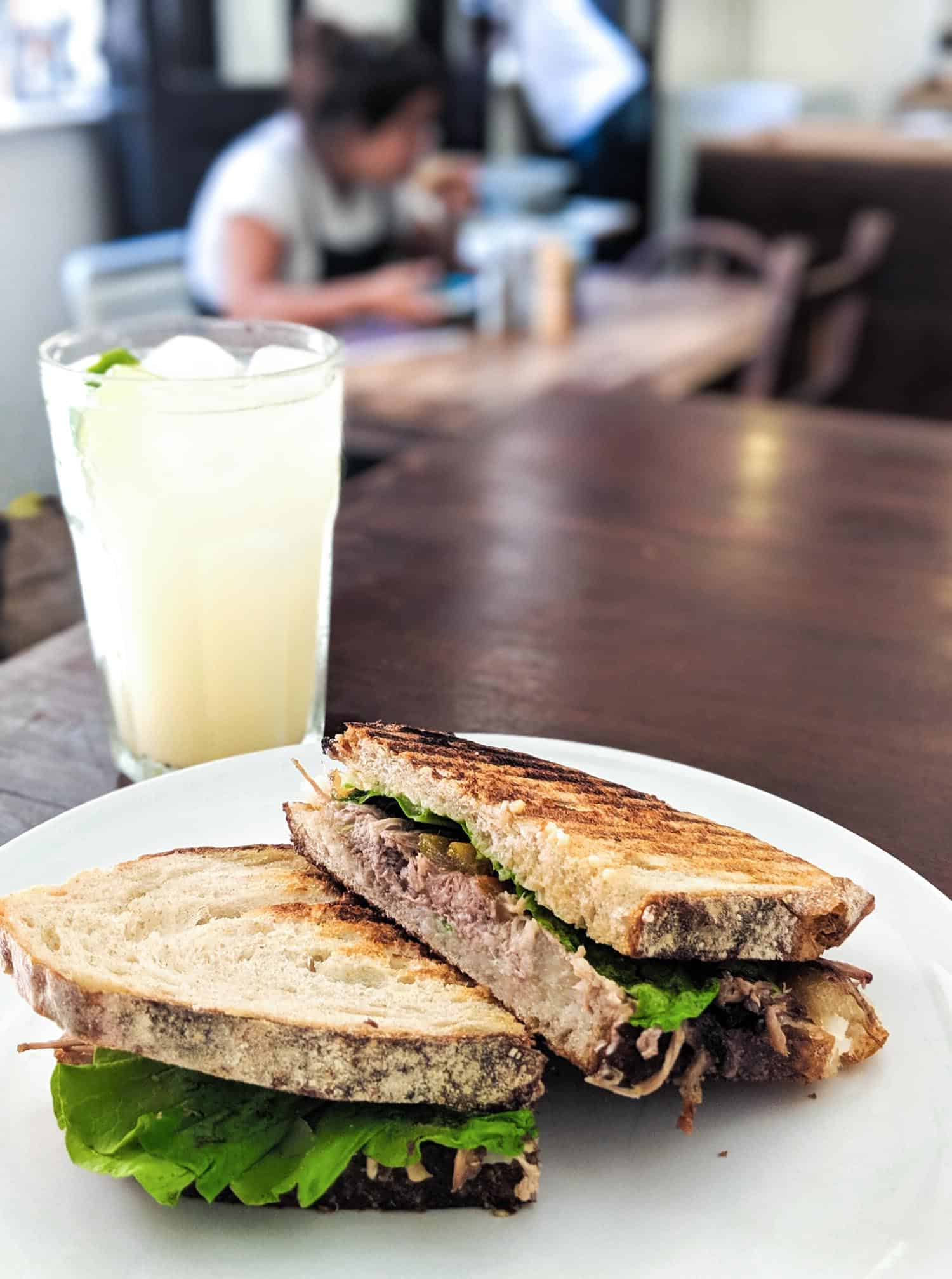 Pork sandwich and drink at El Cafe in Old Havana