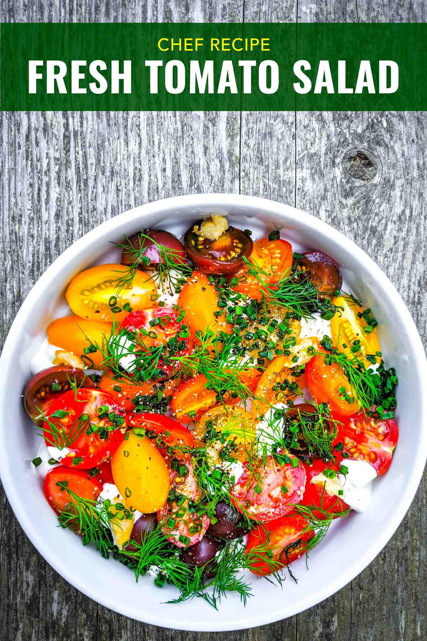 Fresh cherry tomato salad with herbs and creme fraiche in white bowl on grey wood background