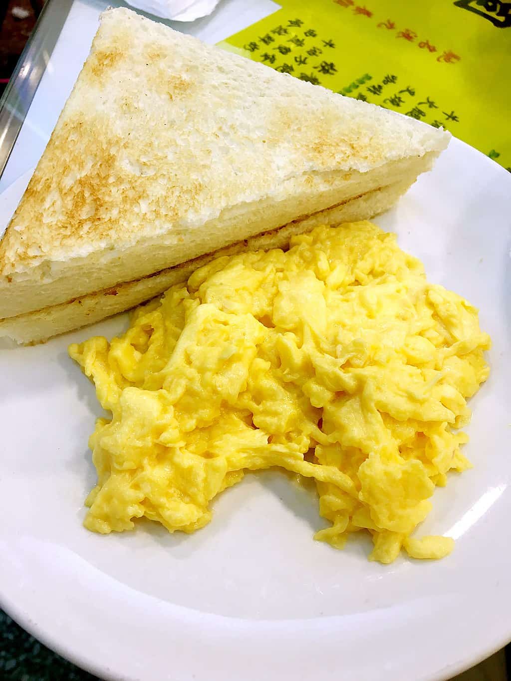 Scrambled egg sandwich on a white plate, common Hong Kong cuisine