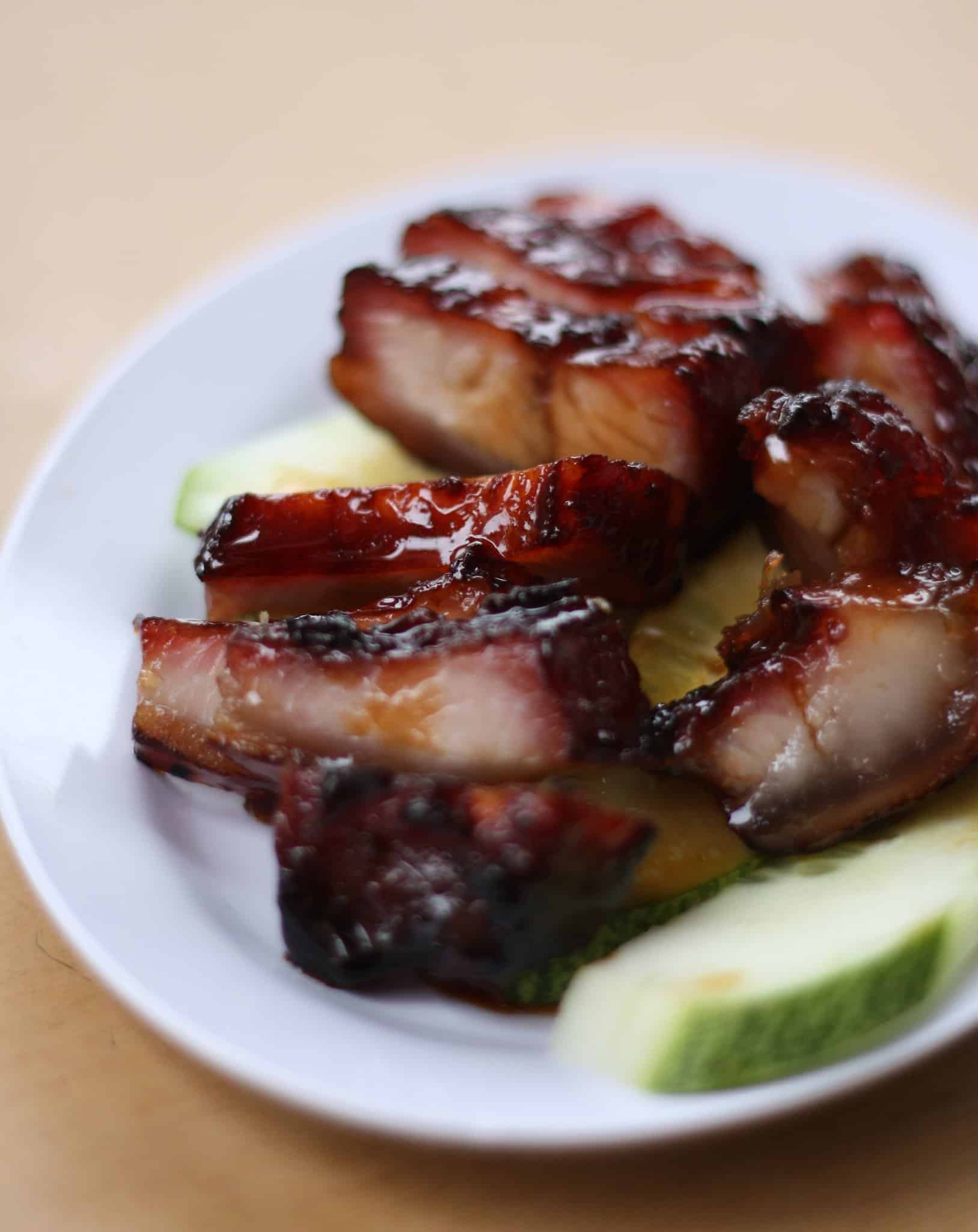 Char siu, traditional Hong Kong cuisine, pork on a white plate.