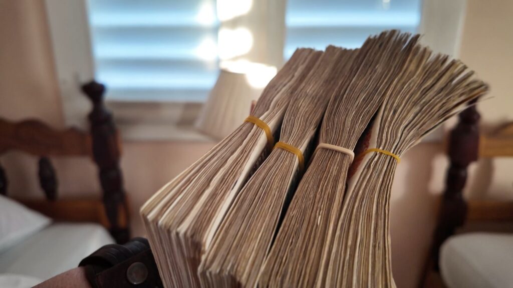 Stack of money in Cuba with elastic bands around the stacks in a Cuban home