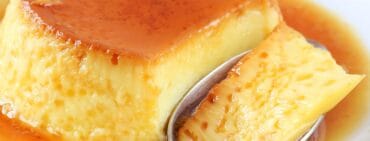 Cuban flan with a spoon on a white plate