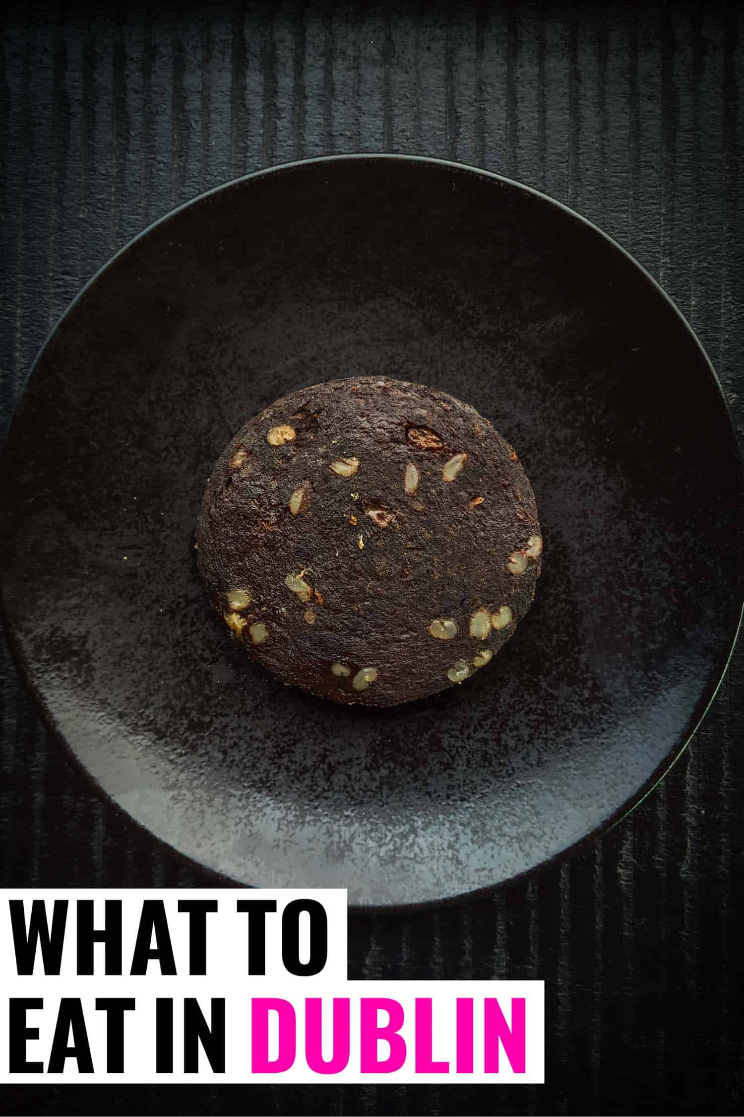 Typical Dublin food, black pudding on a black plate and background.