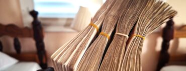 Stack of money in Cuba with elastic bands around the stacks in a Cuban home