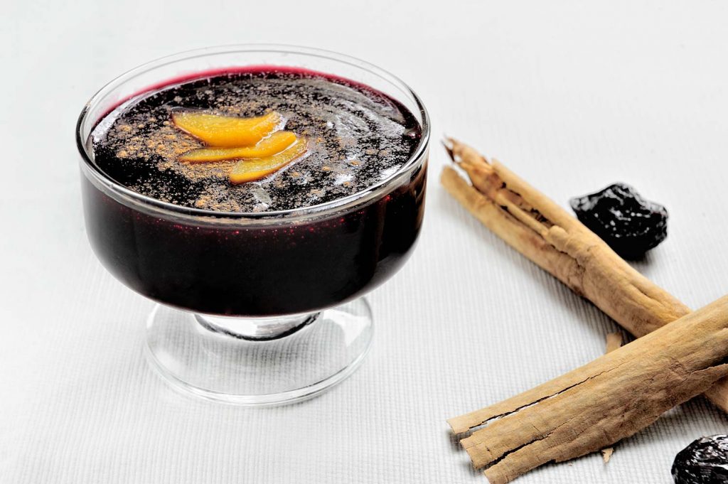 Popular Peruvian dessertss called Mazamorra Morada made out of purple corn with cinnamon sticks.