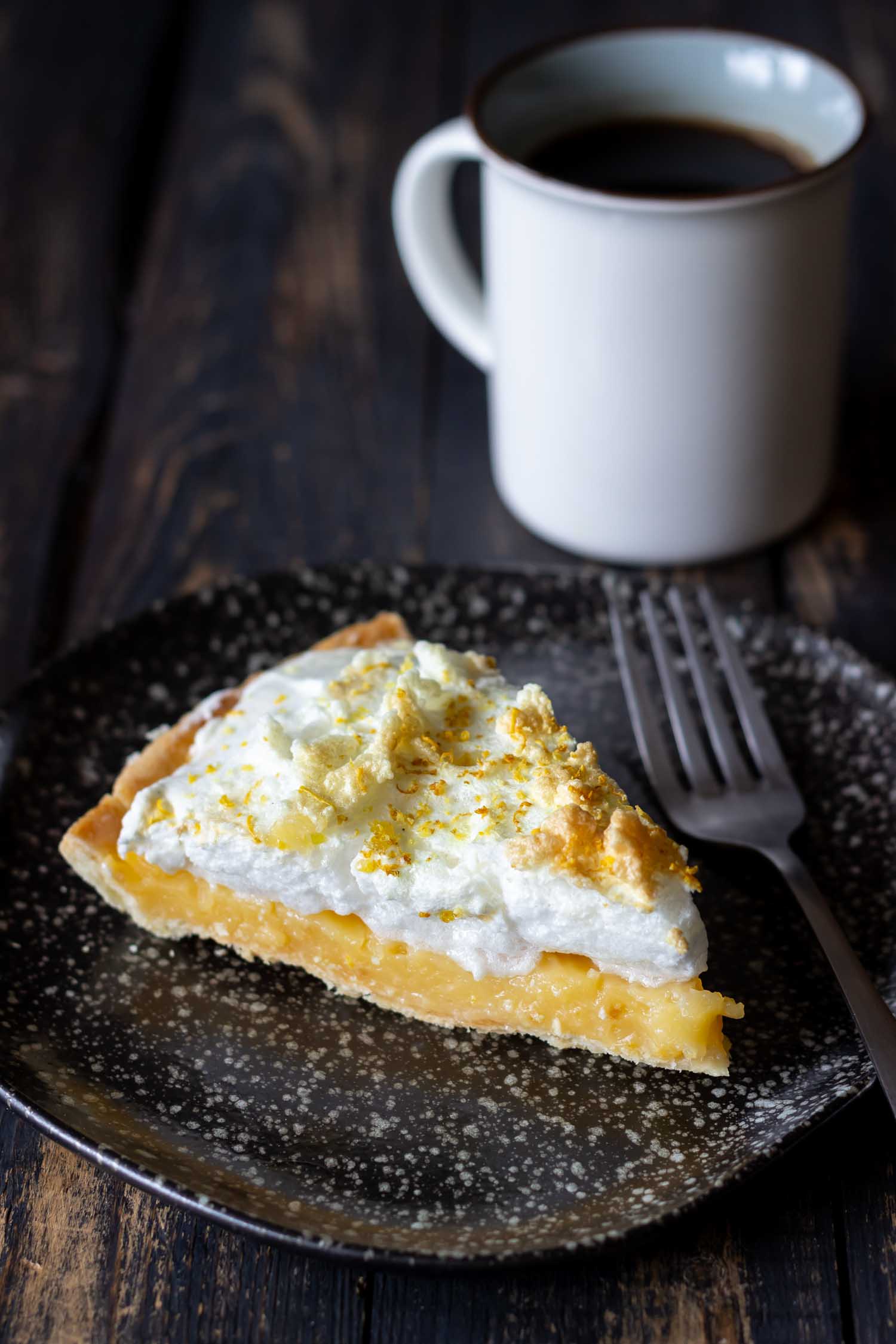 In Peru with lemon meringue on a wooden background. Tart. Bakery products. Dessert. Homemade food.