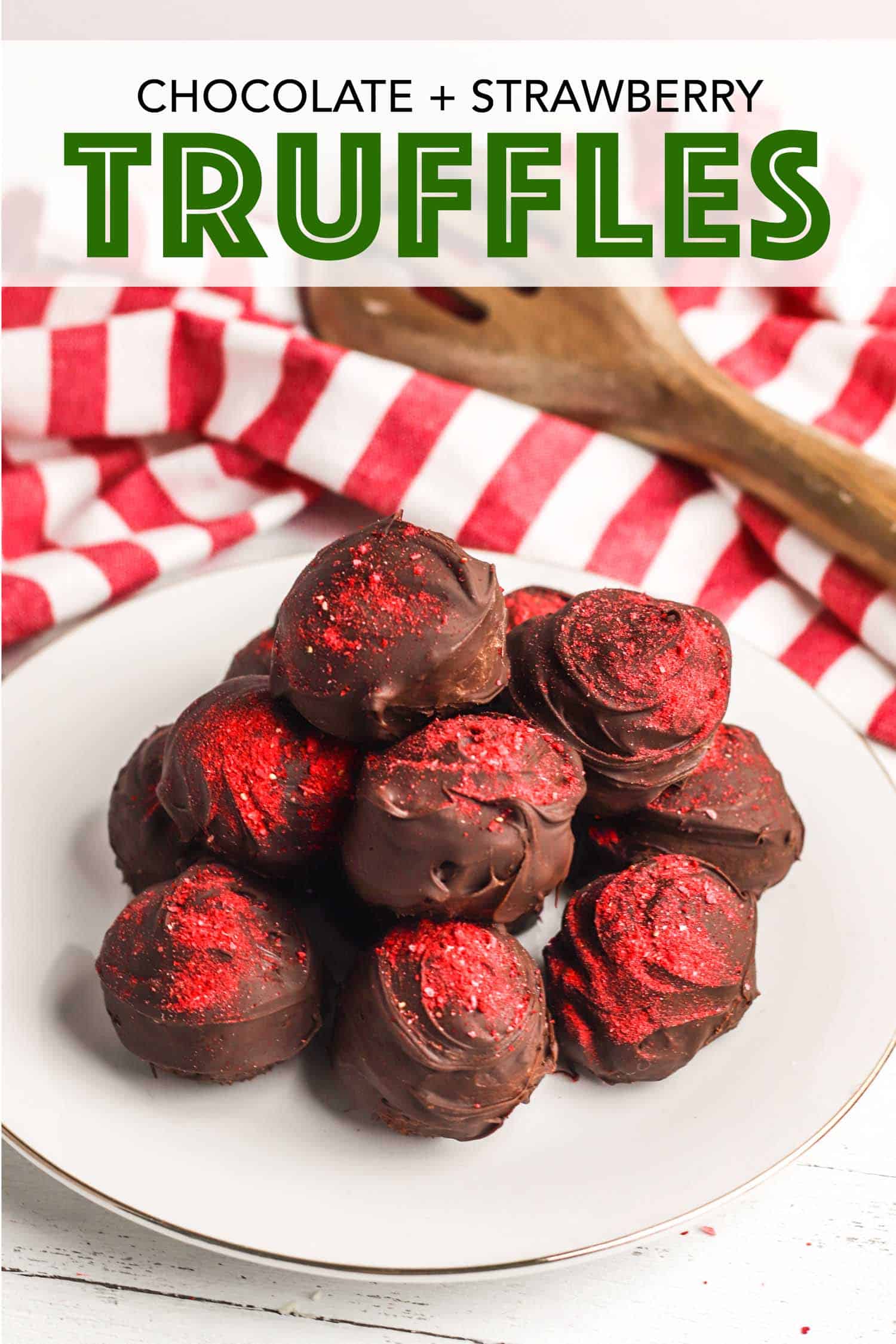 Chocolate strawberry truffles on a white plate with a red and white tea towel.