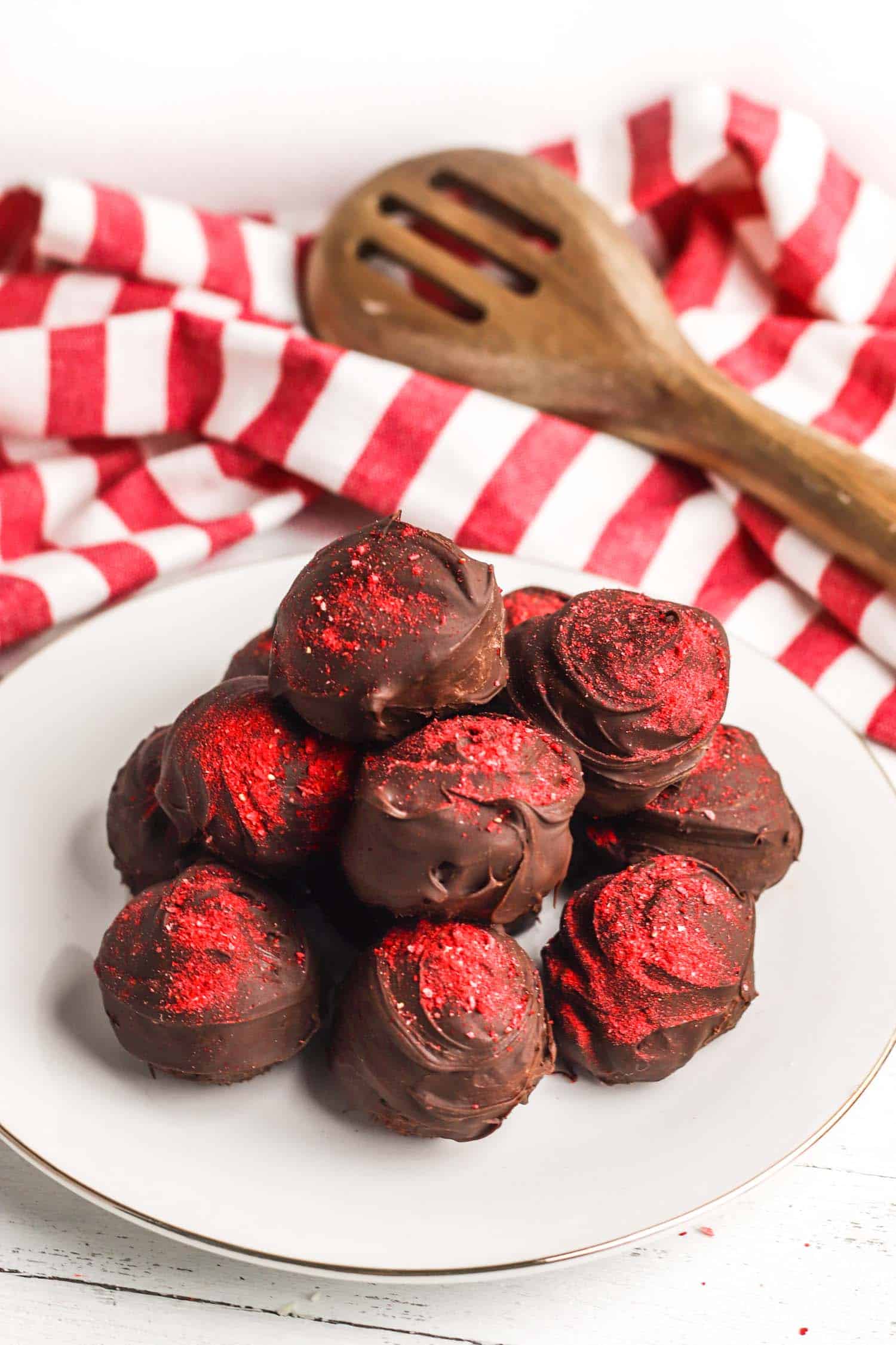 Pile of chocolate truffle with strawberry on a plate