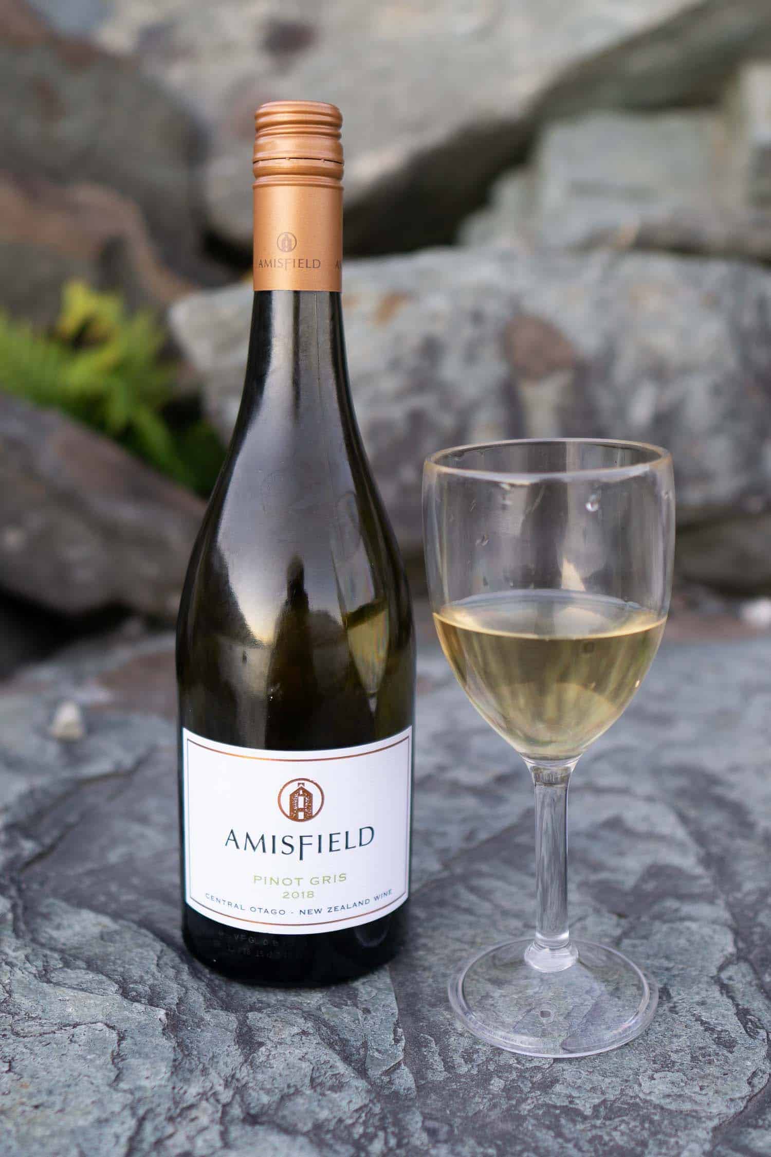 Bottle of Matawhero Wines and glass of wine, one of the most popular vineyards in New Zealand.