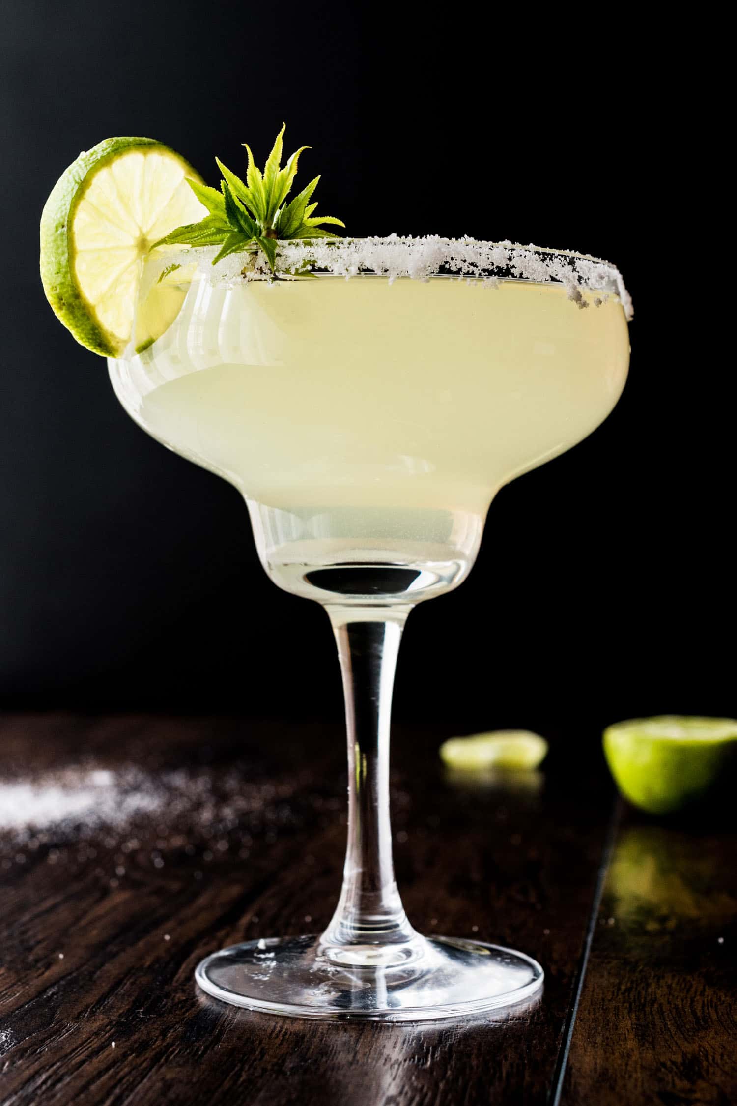 One of the most popular drinks in Mexico, a classic margarita set on a bar with a black background.