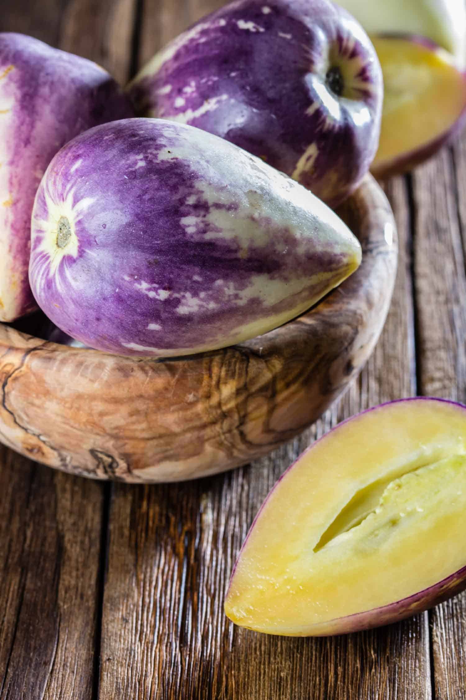 Peruvian fruits sweet cucumber. Pepino dulce or pepino melon on wooden background