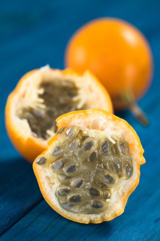 Peru fruit sweet granadilla or grenadia (lat. Passiflora ligularis) fruit cut in half of which the seeds and the surrounding juicy pulp is eaten or is used to prepare juice