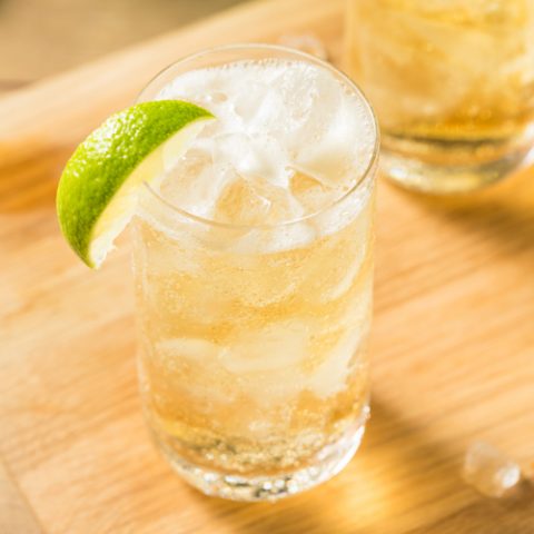 Peruvian Chilcano cocktail served in a glass over ice and garnished with a lime.