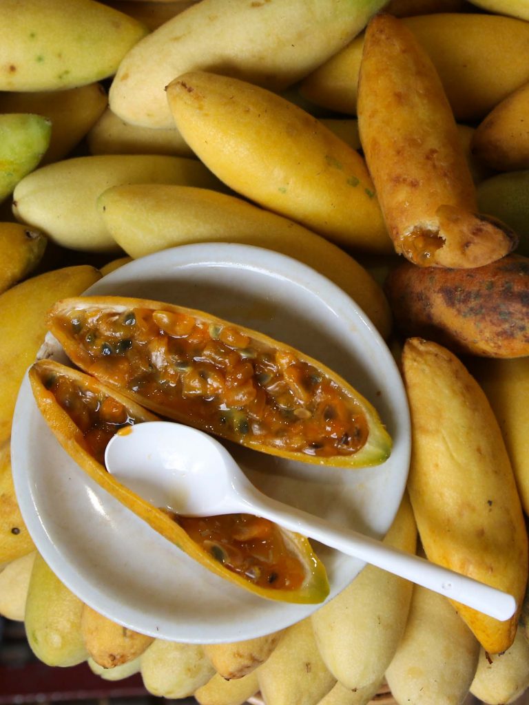 Tumbo Yellow banana pasion fruit Passiflora edulis with spoon and plate