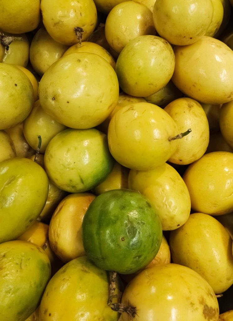 Delicious and juicy passion fruit heap. Maracuya, Passiflora edulis produce. Acid flavor, group of tropical fruits.