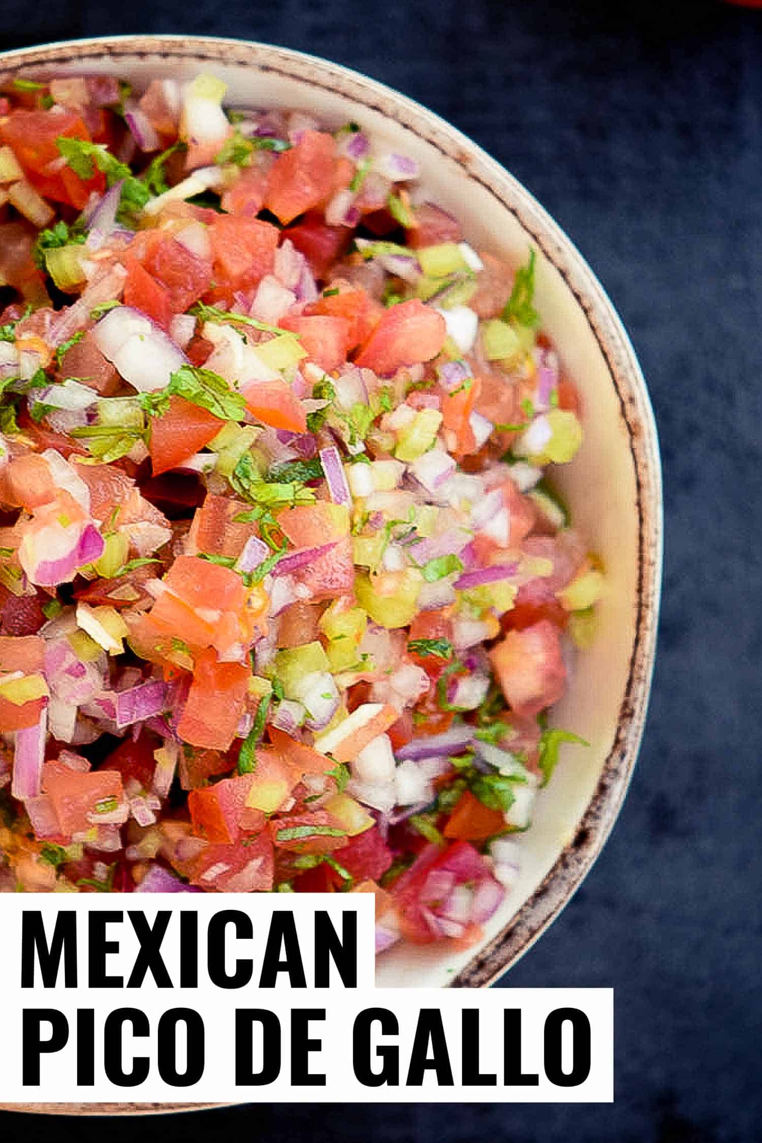 Pico de gallo in a rustic bowl on blue background