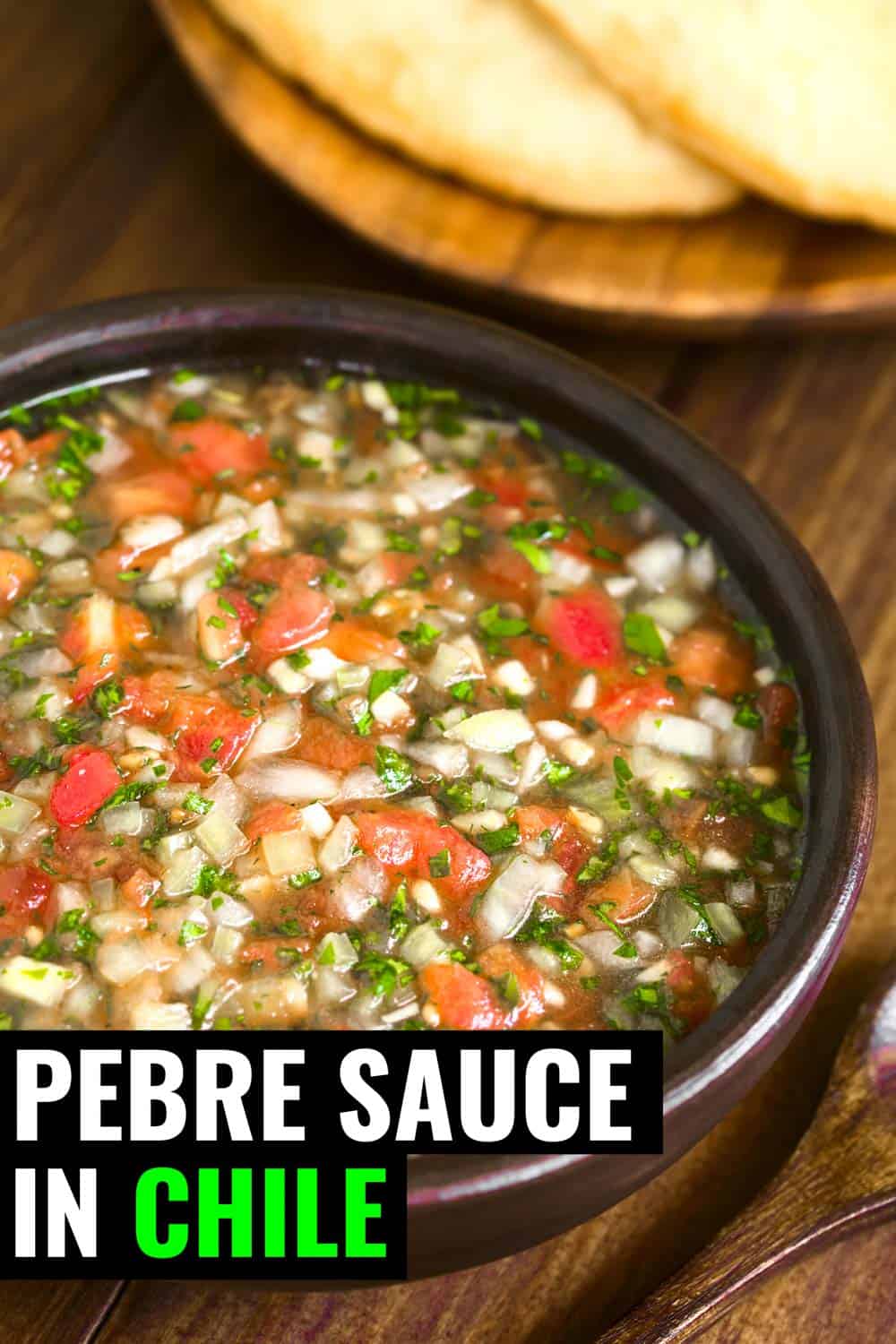 Chilean salsa known as pebre sauce on a table with bread