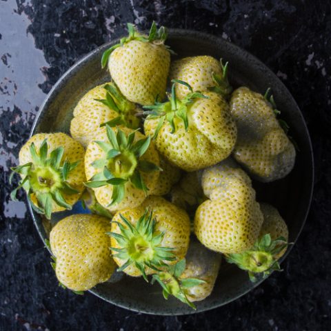 Green strawberries, pickled in a bowl