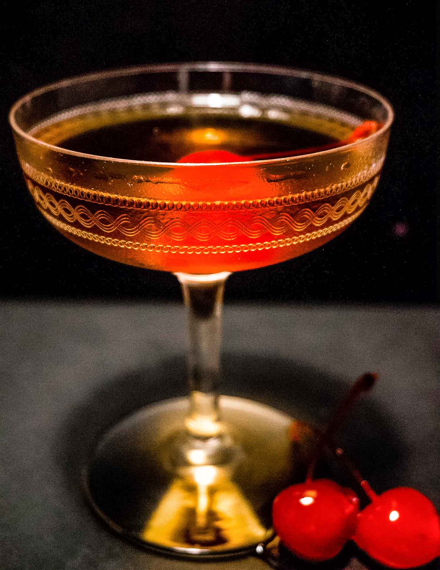 Manhattan Whiskey cocktail on a black background