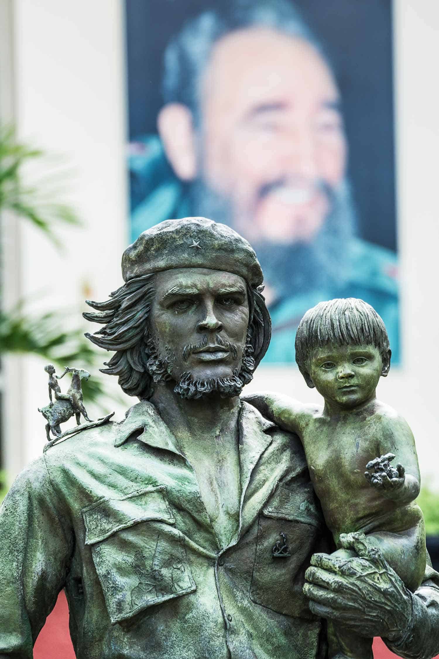 Ernesto Che Guevara with a child in his arms and in the background the image of Fidel Castro, Santa Clara Cuba