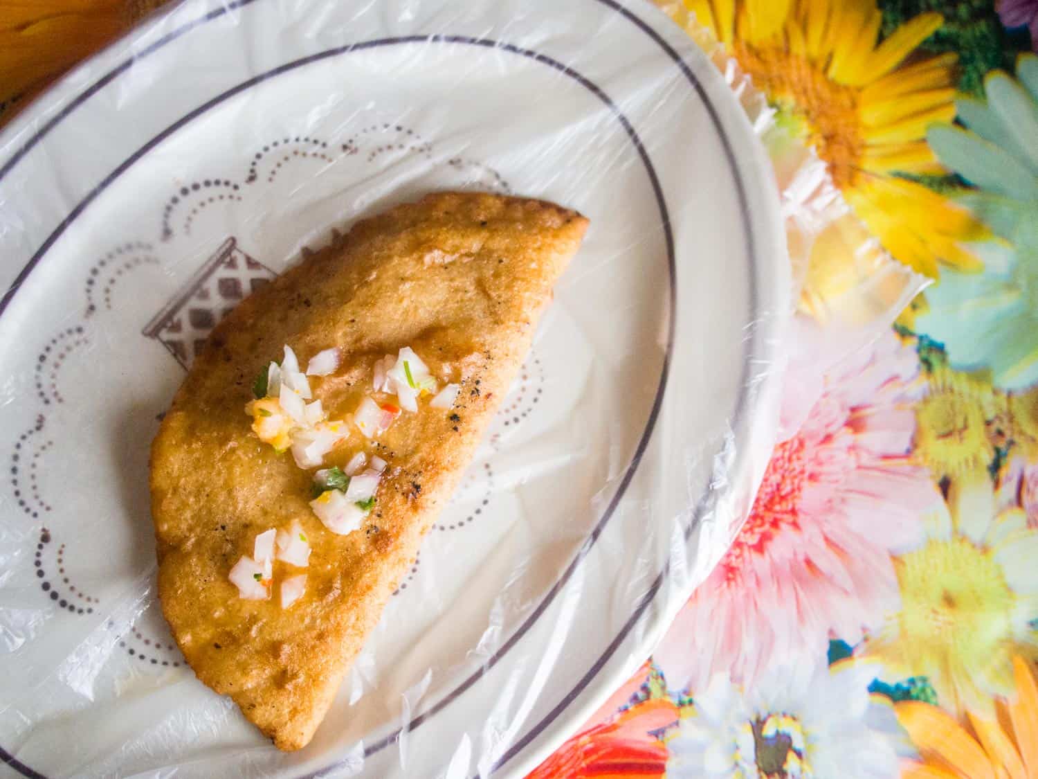 Belizean food panades or small empanadas on a colourful tablecloth