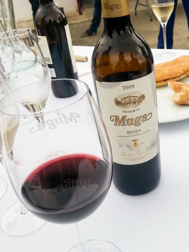 Wine from Spain, a bottle of Muga and glass of red wine on table