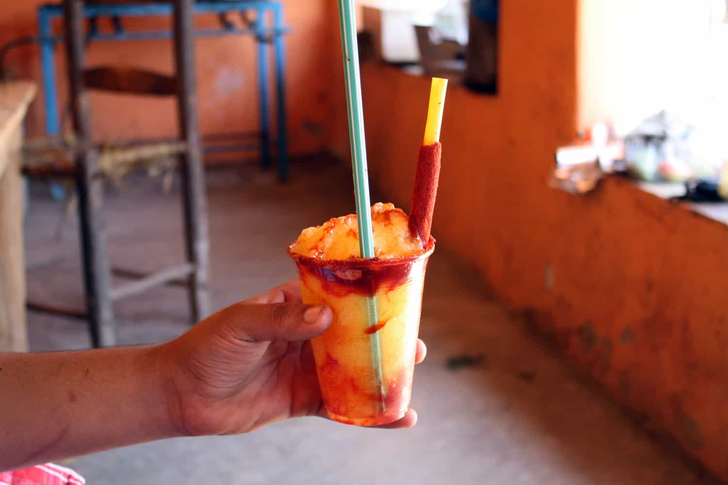 Mexican chamoyada drink in a man's hand.