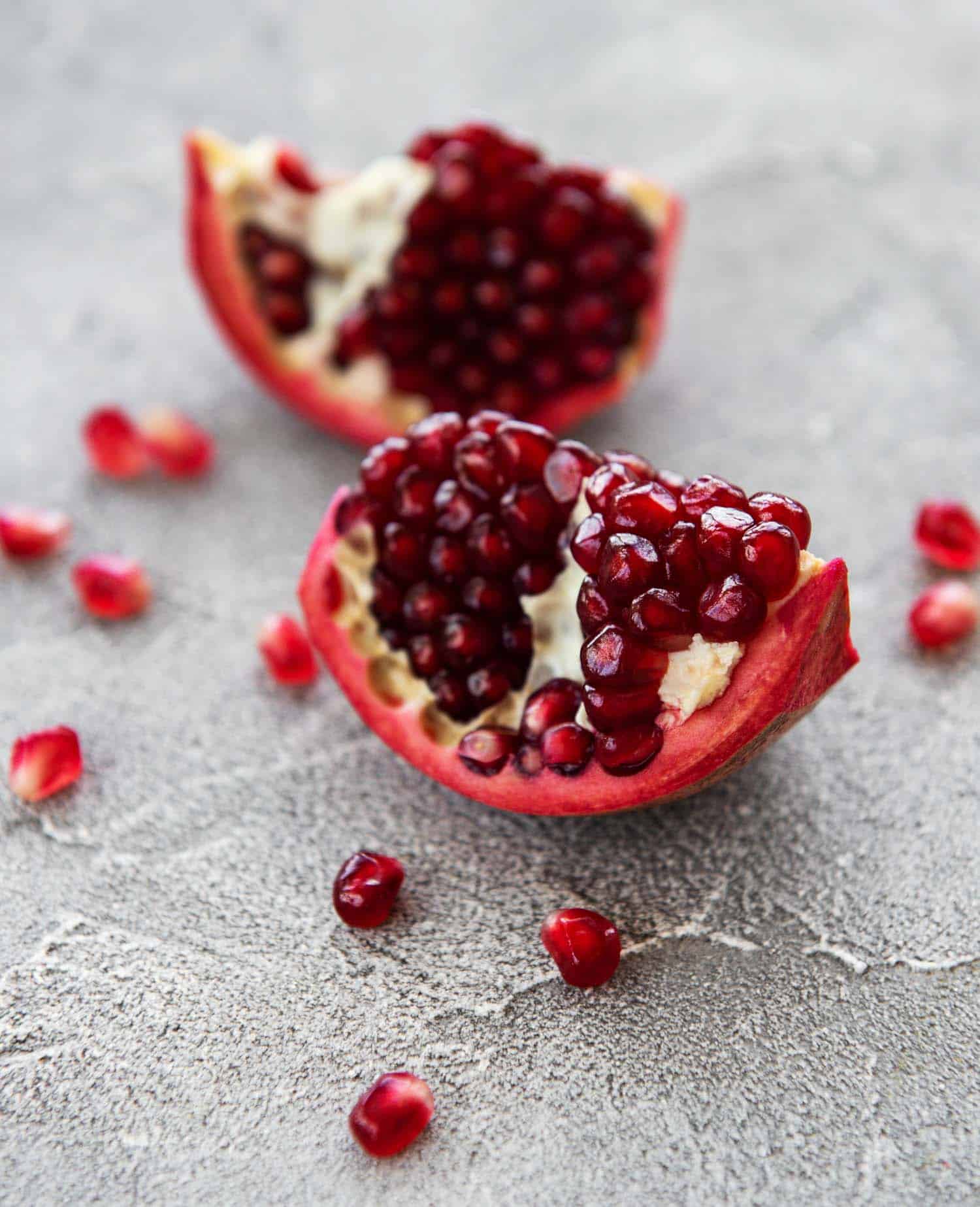 Ripe pomegranate fruits on wooden vintage background