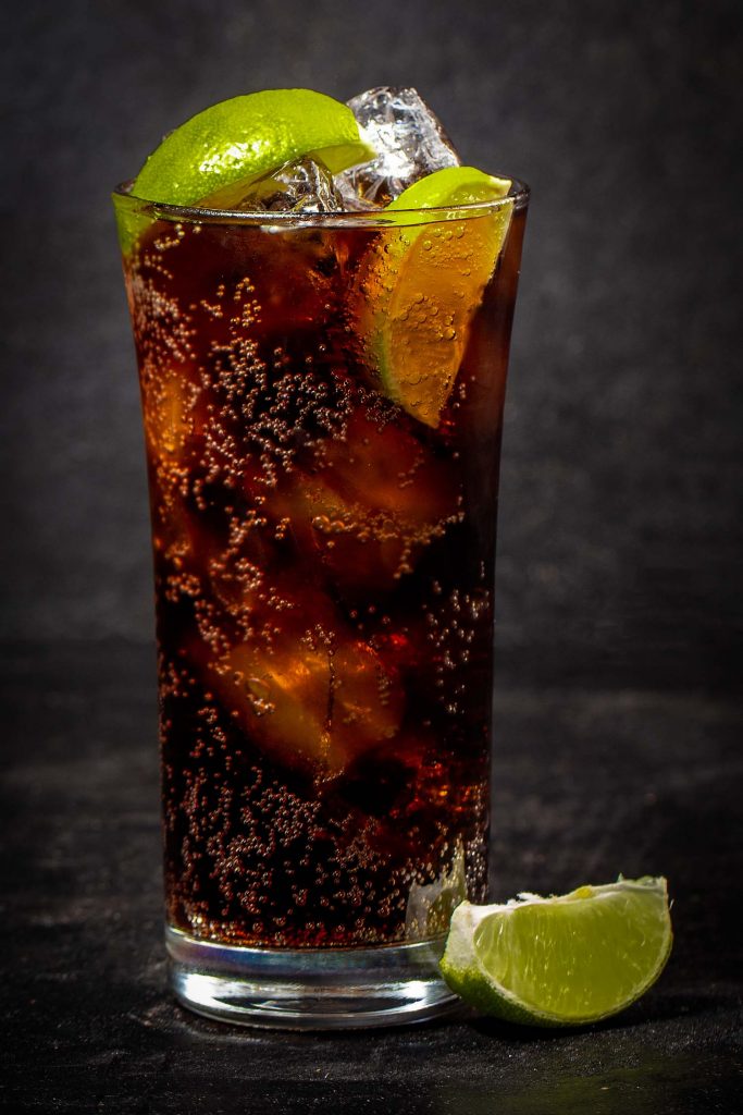 Charro negro cocktail with lime on a black background