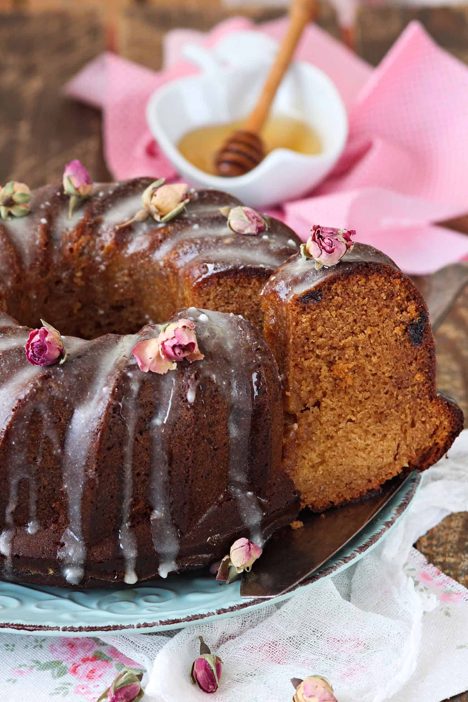 Honey cake, a traditional Rosh Hashanah food, drizzled in honey with a slice cut out.