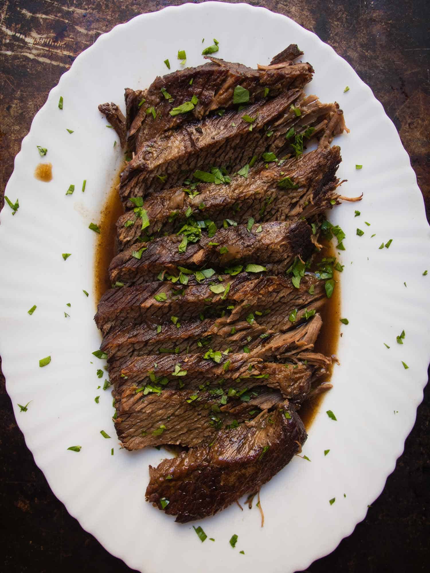 Sliced brisket on a white plate