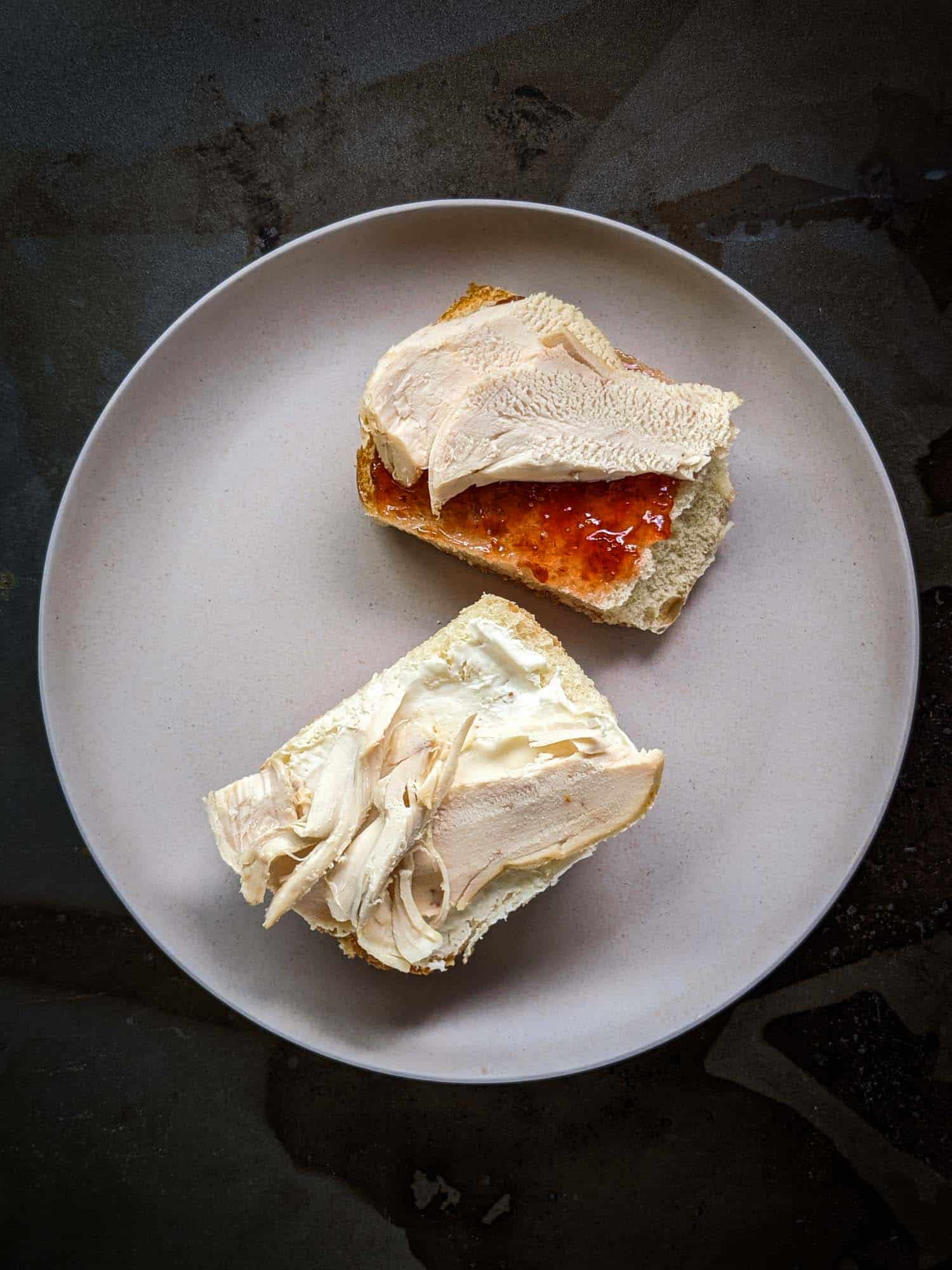 Cuban turkey sandwich with strawberry on one side and cream cheese on the other.