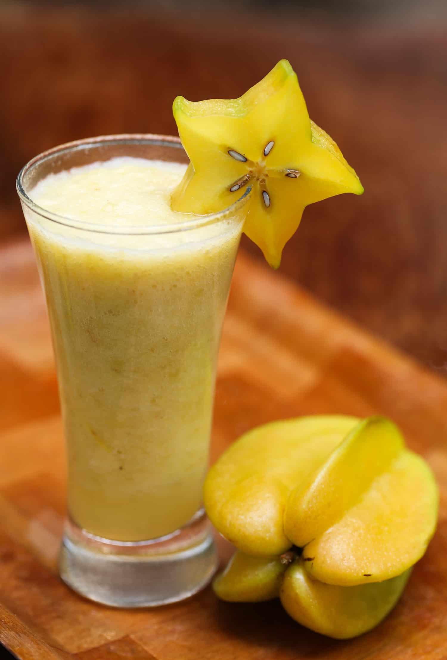 Kamranga also known as Carambola or starfruit juice in a glass with ripe fruit