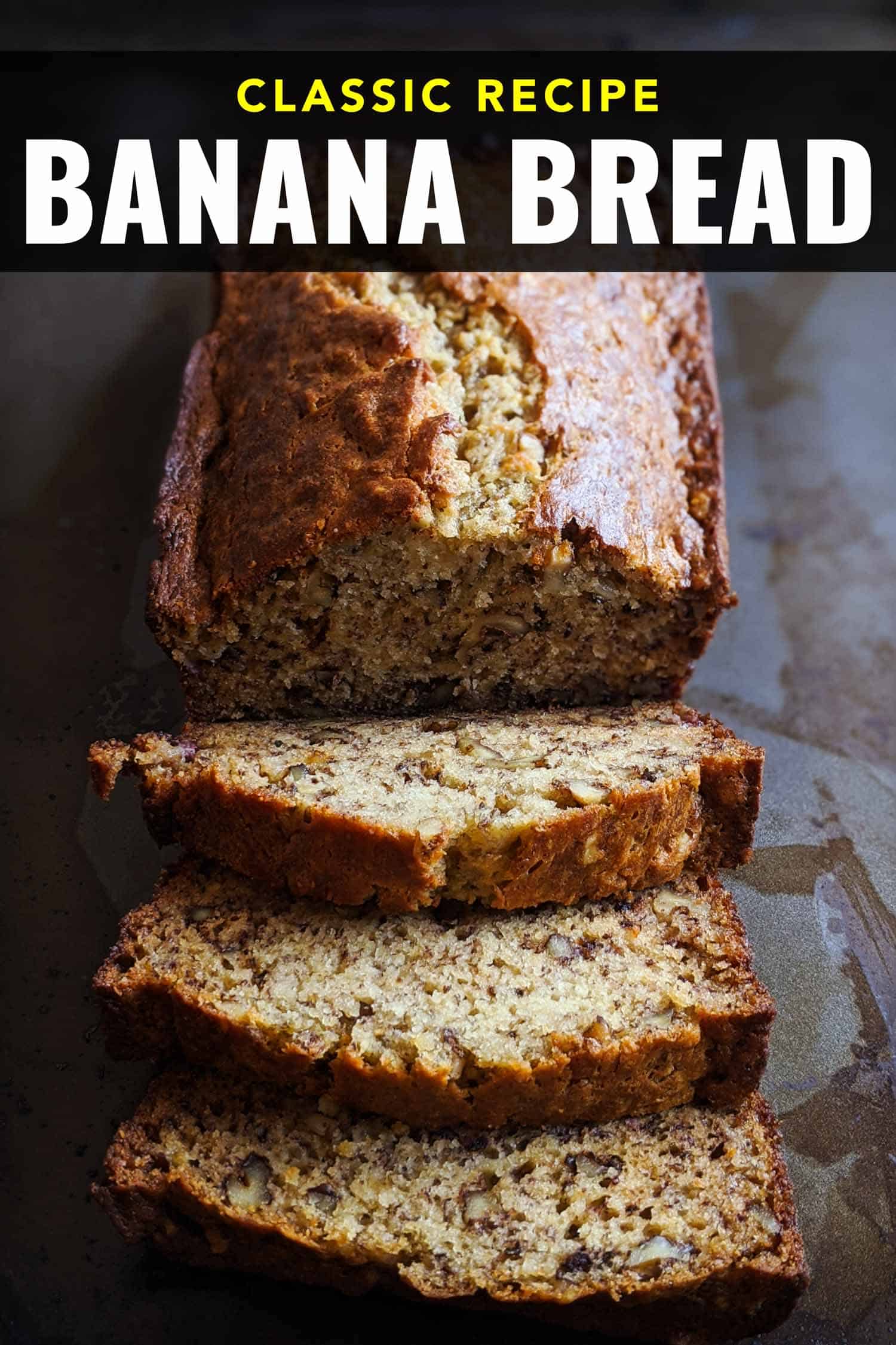 Classic banana bread on a tray, one slice is buttered