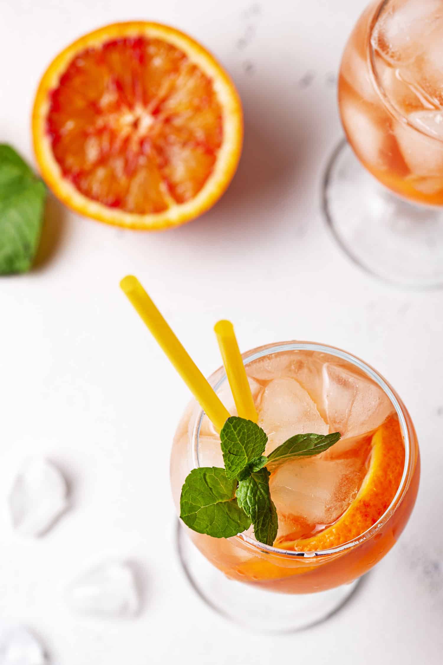 Glass of Aperol Spritz with white background and garnishes. Popular cocktails around the world
