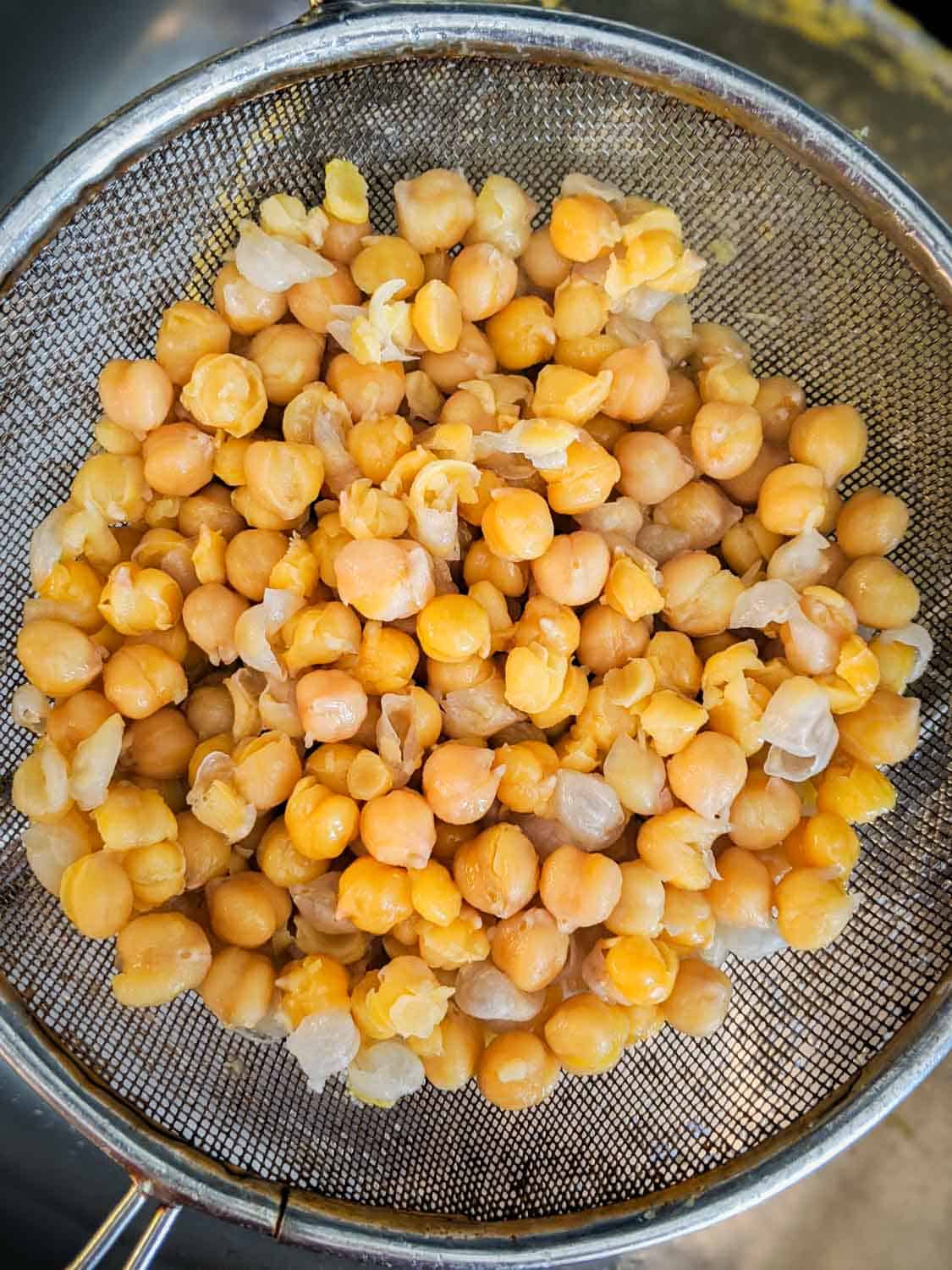 Cooked chickpeas also known as garbanzo beans in a strainer