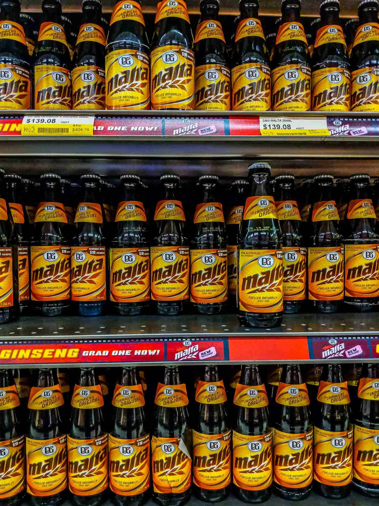 Drinks in Jamaica, a wall of Malta drink in a supermarket