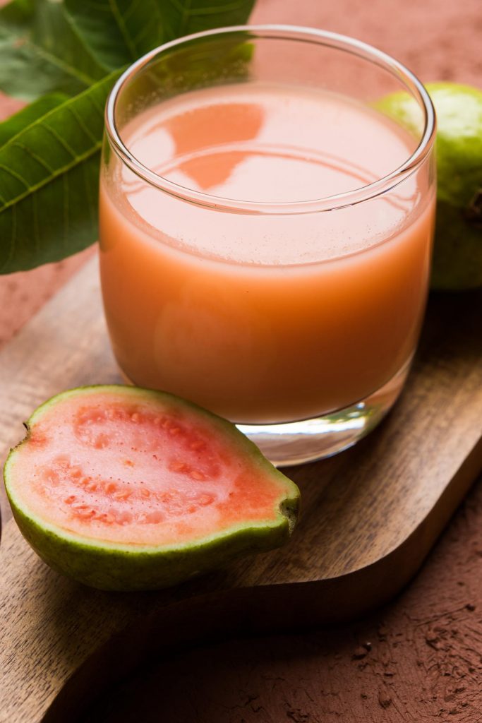 Jamaican fruit Guava juice or Amrud drink or Smoothie with fresh Guava fruit, moody lighting selective focus
