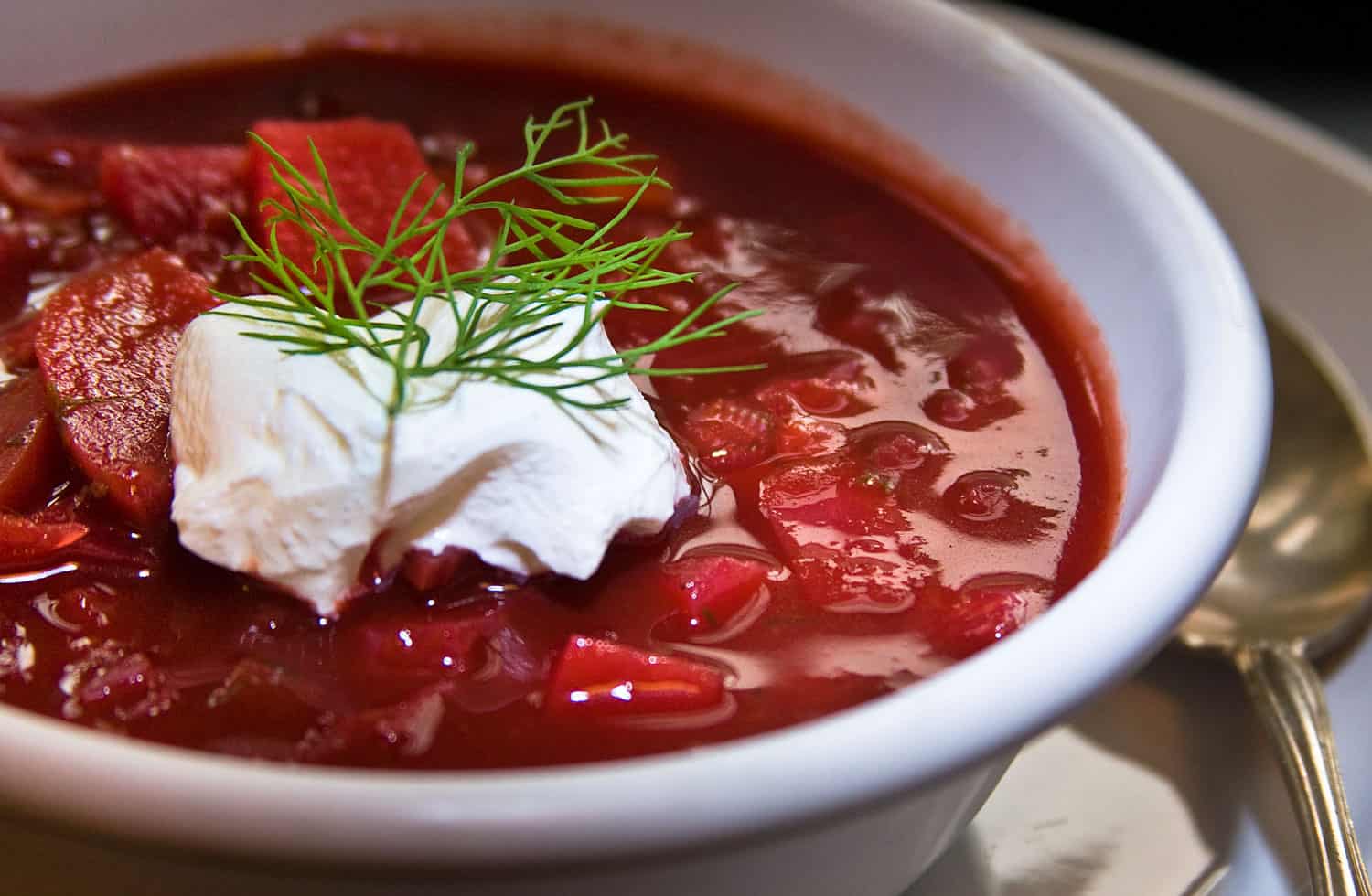 Beet borscht soup with sour cream.