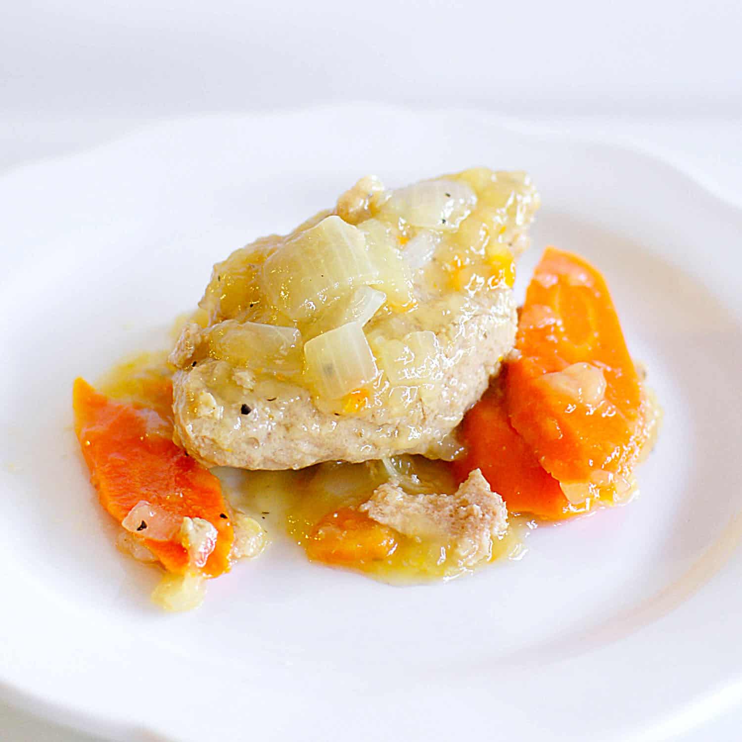 Gefilte fish on a white plate.