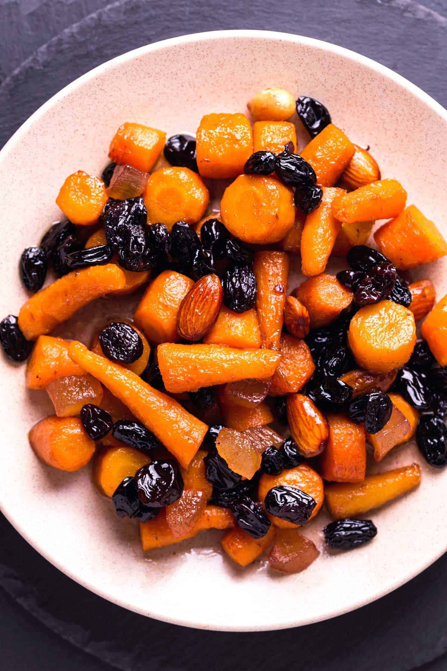 Jewish holiday food favourite tzimmes vegetarian dish with carrots, almonds and raisins