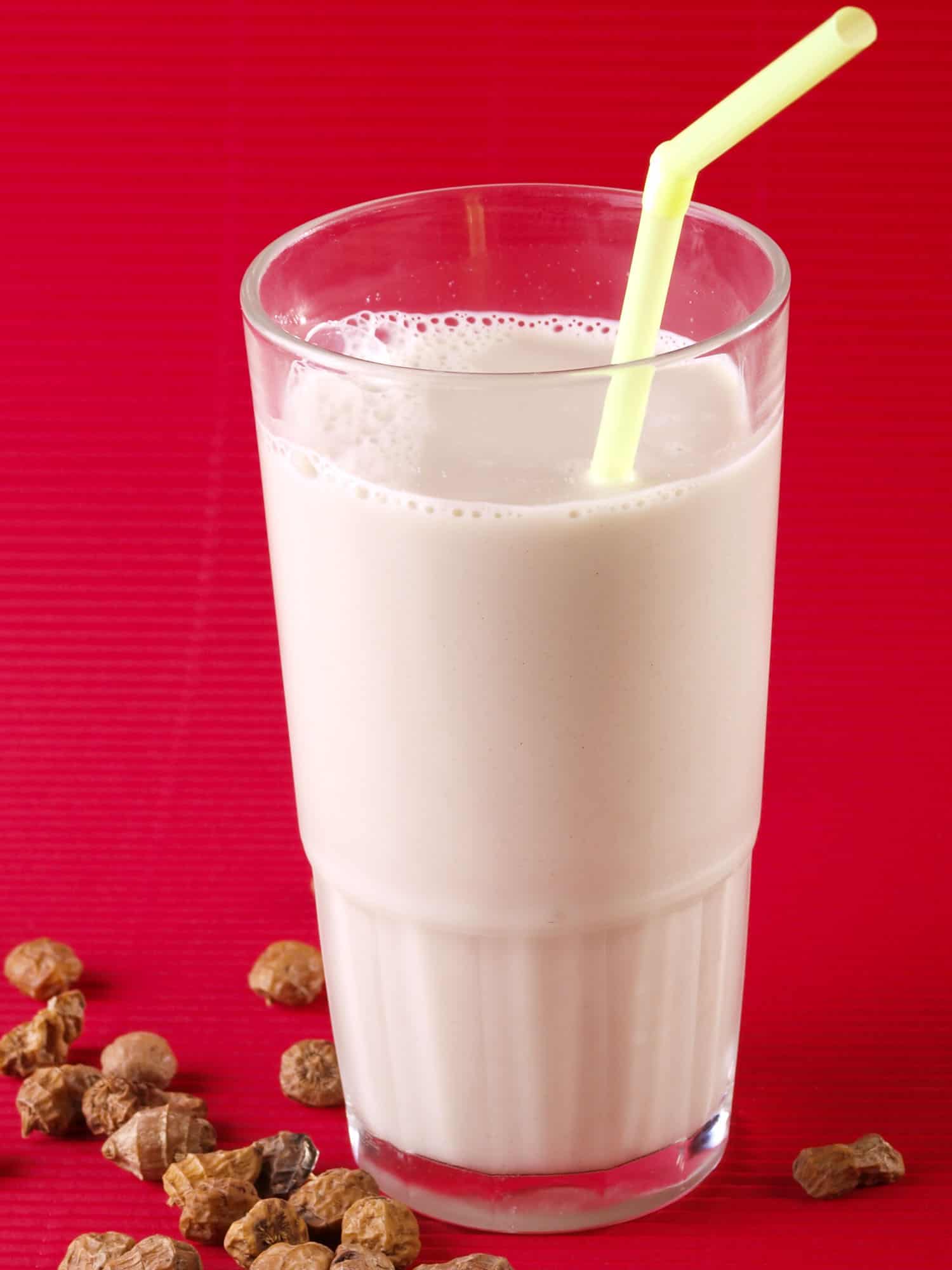 Horchata on a red background with a straw