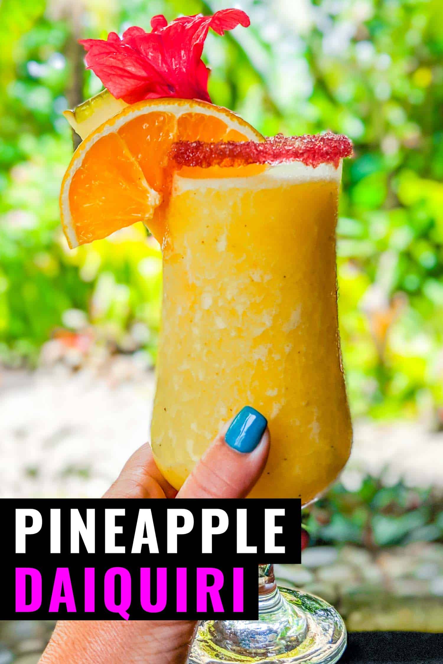 Frozen pineapple daiquiri in a woman's hand.