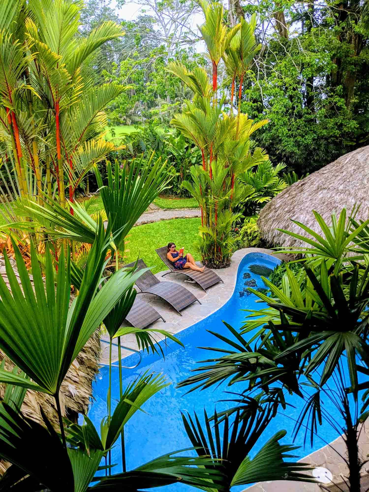 Hotel Banana Azul woman on chair by pool.