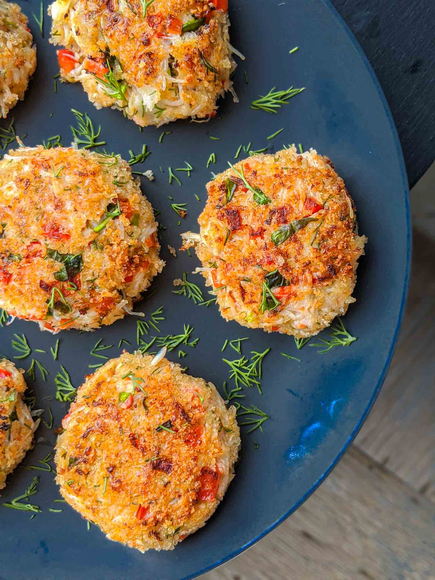 Top view of a plate of Cape Breton crab cakes garnished with dill