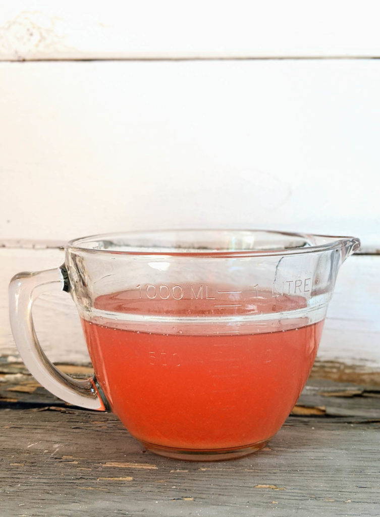 Finished Rhubarb soda called rhabarberschorle in a measuring cup