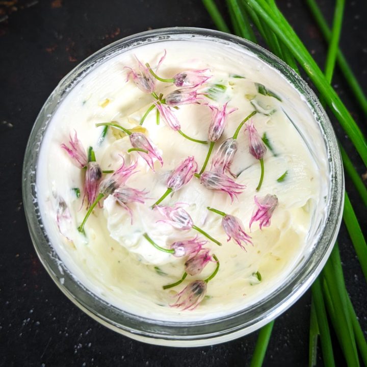 chive butter in a mason jar on a dark background