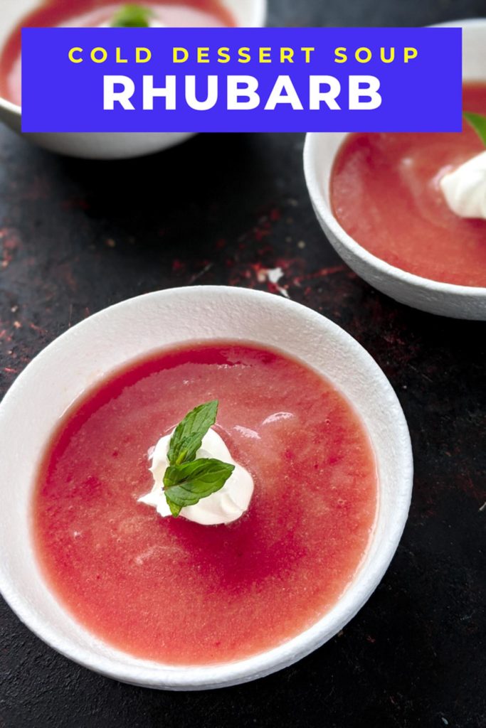 Cold rhubarb soup topped with whipped cream and mint in three white bowls on a black background and text that says cold dessert soup rhubarb