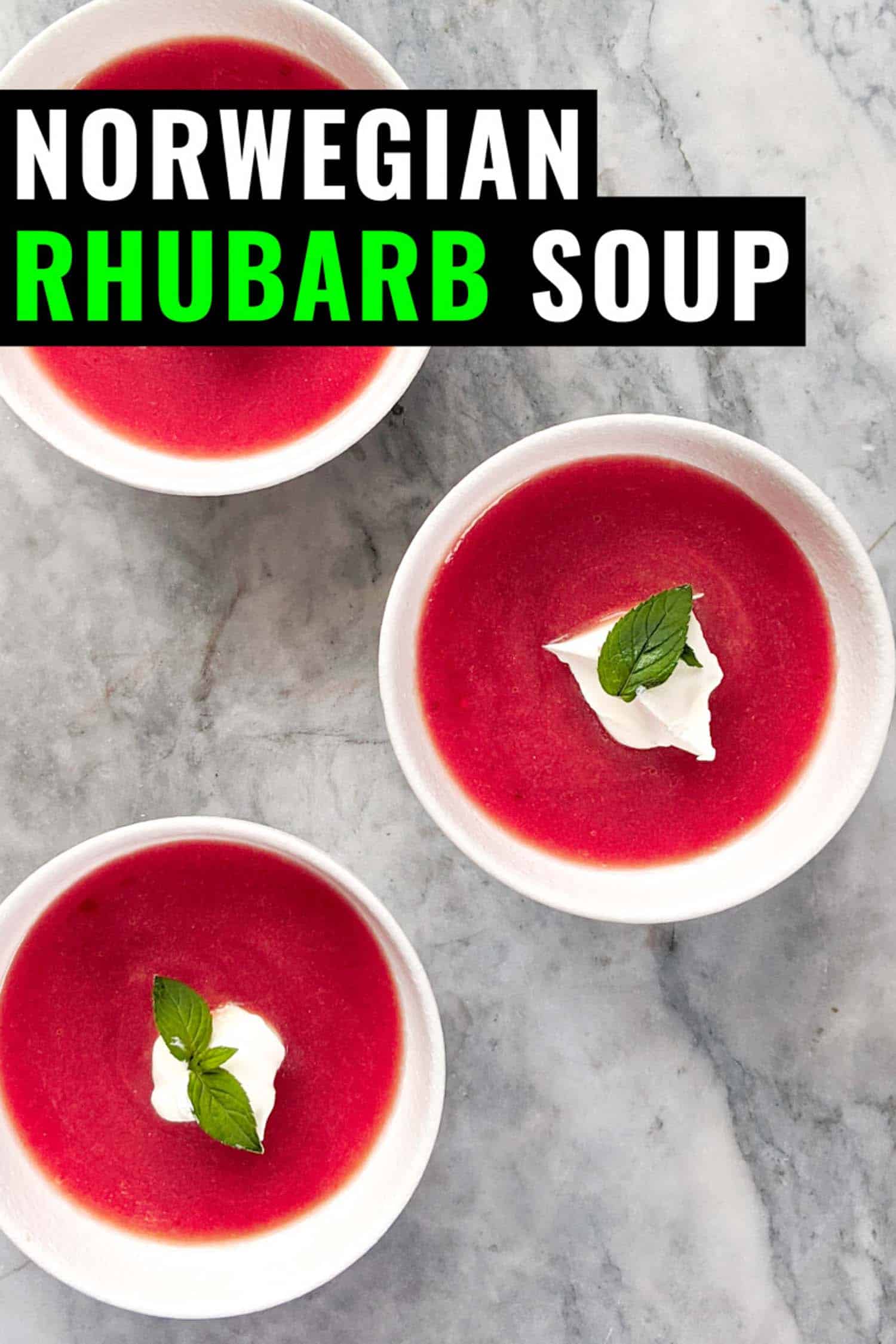 Cold rhubarb soup topped with whipped cream and mint in three white bowls on a grey marble background with text norwegian rhubarb soup